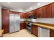 Beautiful kitchen with stainless steel appliances, brown cabinets, and tile flooring at 19700 N 76Th St # 1080, Scottsdale, AZ 85255