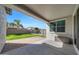 Covered patio overlooking a lush backyard with a pool and privacy fence at 20159 E Rosa Rd, Queen Creek, AZ 85142