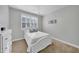 Cozy bedroom with a white bedframe, matching bedside table, and window with plantation shutters at 20159 E Rosa Rd, Queen Creek, AZ 85142