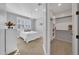 Cozy bedroom with a white bedframe, matching bedside table, a walk-in closet, and window with shutters at 20159 E Rosa Rd, Queen Creek, AZ 85142