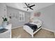 Bright bedroom with a white bedframe, matching bedside table, heart decor, and window with plantation shutters at 20159 E Rosa Rd, Queen Creek, AZ 85142