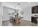 Dining area with a rustic wood table and stylish light fixture at 20159 E Rosa Rd, Queen Creek, AZ 85142