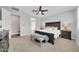 Spacious main bedroom with ceiling fan, ensuite bathroom, and large bed with bench seating at the foot at 20159 E Rosa Rd, Queen Creek, AZ 85142
