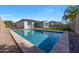 Inviting pool with a stone surround and fenced-in backyard at 20159 E Rosa Rd, Queen Creek, AZ 85142