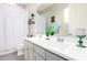 Bright bathroom features a double sink vanity, framed mirror, and a shower-tub combo with white shower curtain at 20325 E Hummingbird Dr, Queen Creek, AZ 85142