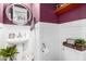 Stylish powder room with pedestal sink, wood shelf, and decorative accents at 20325 E Hummingbird Dr, Queen Creek, AZ 85142