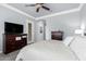 Comfortable bedroom with wood floors, a ceiling fan, and a large dresser at 20325 E Hummingbird Dr, Queen Creek, AZ 85142