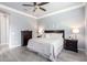 Bedroom with neutral colors, ceiling fan, and dark wood furniture at 20325 E Hummingbird Dr, Queen Creek, AZ 85142