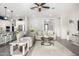 Inviting open-concept living room with hardwood floors, neutral colors, and seamless flow to kitchen at 20325 E Hummingbird Dr, Queen Creek, AZ 85142