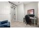 Office with gray walls, computer desk, sliding barn door, and blue leather chair at 20325 E Hummingbird Dr, Queen Creek, AZ 85142