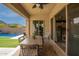 Covered patio with outdoor dining overlooking the pool and landscaped backyard at 20325 E Hummingbird Dr, Queen Creek, AZ 85142