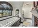 Beautiful bathroom showcasing a jacuzzi tub, designer windows, arched ceilings, marble floors, and high-end fixtures at 20715 N 103Rd Pl, Scottsdale, AZ 85255