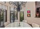 Bright dining area with a modern chandelier, garden views, and room for entertaining guests at 20715 N 103Rd Pl, Scottsdale, AZ 85255