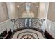 Grand foyer showcasing a decorative railing, exquisite tile work, and an ornate chandelier at 20715 N 103Rd Pl, Scottsdale, AZ 85255