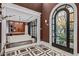 Stunning foyer with arched doorway, detailed millwork, and views into the living area at 20715 N 103Rd Pl, Scottsdale, AZ 85255