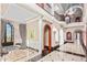 Spacious home foyer with an arched glass door, black and white flooring, and views of the second story balcony at 20715 N 103Rd Pl, Scottsdale, AZ 85255