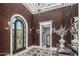 Elegant foyer featuring high ceilings, a statement chandelier, and a grand arched doorway at 20715 N 103Rd Pl, Scottsdale, AZ 85255