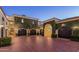 Spacious garage facade covered in lush vines, featuring multiple doors and elegant lighting, adding charm at 20715 N 103Rd Pl, Scottsdale, AZ 85255
