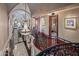 Elegant hallway with a crystal chandelier, curved staircase, and access to various rooms at 20715 N 103Rd Pl, Scottsdale, AZ 85255