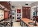 Gourmet kitchen featuring stainless steel appliances, custom cabinetry, and a large island with sink at 20715 N 103Rd Pl, Scottsdale, AZ 85255