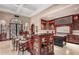 Open kitchen layout with seating at the island, custom cabinetry, and a gourmet cooking area at 20715 N 103Rd Pl, Scottsdale, AZ 85255