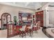 Kitchen with bar seating, custom wood cabinets, and modern appliances at 20715 N 103Rd Pl, Scottsdale, AZ 85255