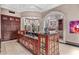 Expansive kitchen featuring a large island, custom cabinetry, and elegant chandeliers at 20715 N 103Rd Pl, Scottsdale, AZ 85255