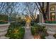 Lush garden featuring mature trees, decorative planters, and a beautiful statue, creating a serene outdoor retreat at 20715 N 103Rd Pl, Scottsdale, AZ 85255