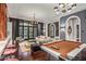 Grand living room with pool table, luxury decor, and floor-to-ceiling glass doors with views to the manicured outdoor living area at 20715 N 103Rd Pl, Scottsdale, AZ 85255