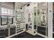 A walk-in closet is bright and luxurious with mirrored cabinets and displays under an arched ceiling and designer touches at 20715 N 103Rd Pl, Scottsdale, AZ 85255