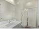 This is a bathroom with a single sink vanity and glass enclosed shower at 20951 E Via Del Sol St, Queen Creek, AZ 85142