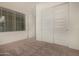 This is a bright bedroom with natural light, a closet and neutral carpet at 20951 E Via Del Sol St, Queen Creek, AZ 85142