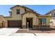 Inviting two-story home featuring a two-car garage, neutral colors, and tasteful stone accents at 20951 E Via Del Sol St, Queen Creek, AZ 85142