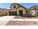 Inviting two-story home featuring a two-car garage, neutral colors, and tasteful stone accents at 20951 E Via Del Sol St, Queen Creek, AZ 85142