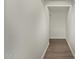 Clean and minimalist hallway featuring textured walls and durable tile flooring at 20951 E Via Del Sol St, Queen Creek, AZ 85142