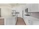 Bright, open kitchen boasts a large island, stainless steel appliances, and white cabinets at 20951 E Via Del Sol St, Queen Creek, AZ 85142