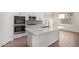 Bright, open kitchen features a large island with stainless appliances and a modern design at 20951 E Via Del Sol St, Queen Creek, AZ 85142