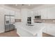 Spacious open kitchen featuring white cabinetry, stainless steel appliances, and a center island at 20951 E Via Del Sol St, Queen Creek, AZ 85142