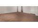 Expansive living room featuring wood-look tile flooring, a staircase, and access to the front door at 20951 E Via Del Sol St, Queen Creek, AZ 85142