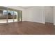 Open-concept living room with sliding glass doors offering ample natural light and wood-look tile floors at 20951 E Via Del Sol St, Queen Creek, AZ 85142