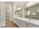 This is a luxurious bathroom featuring a double sink vanity, tile flooring and a glass enclosed shower at 20951 E Via Del Sol St, Queen Creek, AZ 85142
