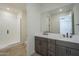 Bathroom featuring a double vanity, modern fixtures, and a walk-in shower with glass doors at 2121 W Sonoran Desert Dr # 13, Phoenix, AZ 85085