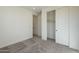 Bedroom with sliding closet doors, neutral carpeting, and natural lighting at 2121 W Sonoran Desert Dr # 13, Phoenix, AZ 85085