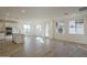 Open-concept living area with wood-look tile flooring and windows for natural light at 2121 W Sonoran Desert Dr # 13, Phoenix, AZ 85085