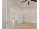 This bedroom features a ceiling fan, neutral carpeting, and leads to an area with ceramic tile flooring at 21320 N 56Th St # 1085, Phoenix, AZ 85054