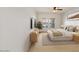 Cozy bedroom featuring a ceiling fan, dresser, and ample natural light at 21320 N 56Th St # 1085, Phoenix, AZ 85054