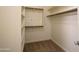 A walk-in closet with carpeting features built-in shelving and closet rods for optimal organization at 21320 N 56Th St # 1085, Phoenix, AZ 85054