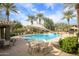 Sparkling community pool with palm trees, lounge chairs, and shaded seating areas at 21320 N 56Th St # 1085, Phoenix, AZ 85054