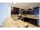 Well-equipped kitchen with granite countertops, stainless steel appliances, and dark cabinets at 21320 N 56Th St # 1085, Phoenix, AZ 85054