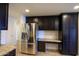 Modern kitchen with stainless steel appliances, granite countertops, and dark cabinets at 21320 N 56Th St # 1085, Phoenix, AZ 85054